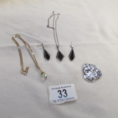 A silver pendant, pair of silver earrings, white metal brooch and pendant on 9ct gold chain