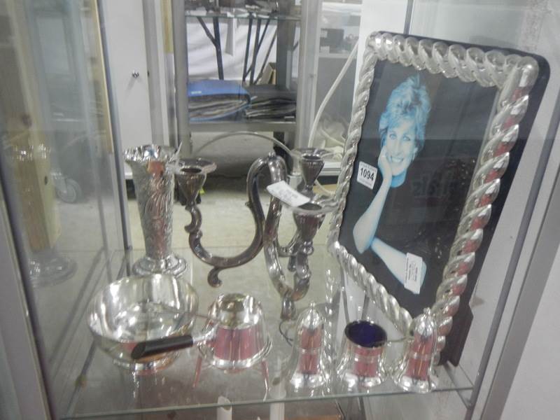 A mixed lot of silver plate including photo frame, condiments, candleholder, vase etc