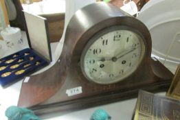 A mahogany inlaid mantel clock