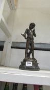 A bronze figure of a boy