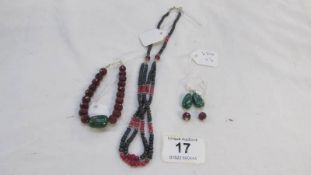 A red and blue bead necklace, bracelet and earrings