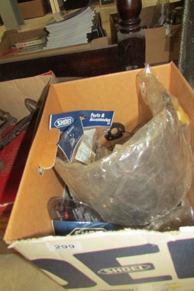 A box of motorcycle visors etc