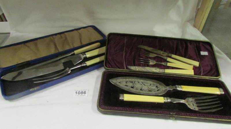 A cased pair of good quality fish servers, a cased carving set etc