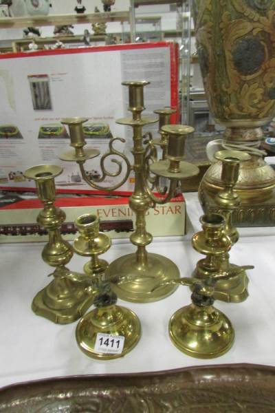A brass candelabra, pair of Victorian brass candlesticks and a pair of eagle candlesticks