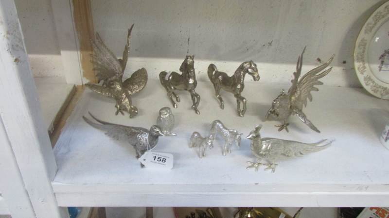 A pair of silver plate fighting cockerels, pair of pheasants, horses, donkey and owl