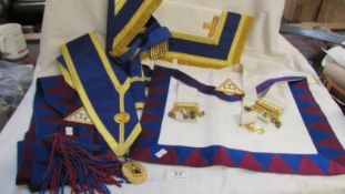 A Masonic apron and sash with jewel together with a Masonic apron and sash with oval Cheshire