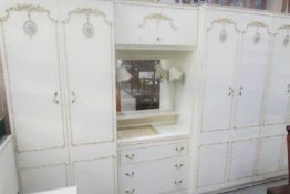 A 3 piece French style bedroom unit comprising 2 wardrobes and central dressing table