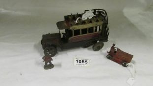 An old tin plate clockwork bus, a die cast fire engine and a lead soldier