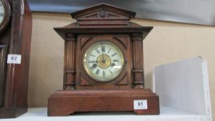 An oak Palladian style mantel clock