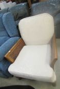 An Edwardian armchair with bergere sides (canework a/f on one side)