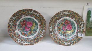A pair of Oriental plates hand decorated in Hong Kong