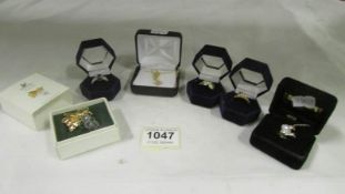 3 stone set dress rings, a Swarovski crystal brooch, a stone set pendant and a stone set lapel pin