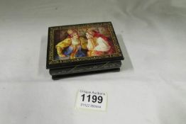A lacquered box depicting Russian ladies