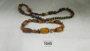 An amber necklace and one other mixed stone necklace including agate