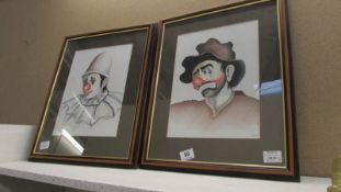 A pair of pastel portraits of clowns signed P McKenna