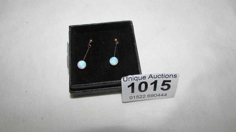 A pair of 9ct gold and opal drop earrings