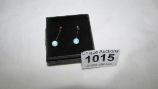 A pair of 9ct gold and opal drop earrings