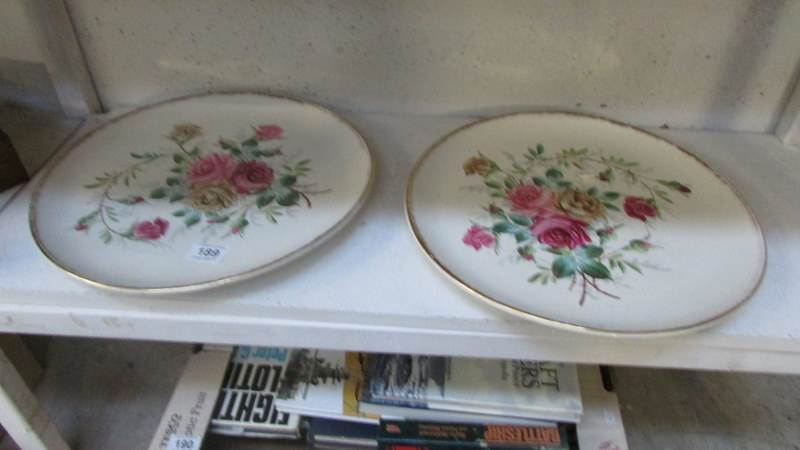 A pair of large Victorian hand painted floral plaques