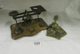 A set of Victorian brass postal scales with weights and a brass inkwell