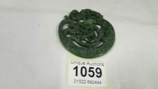 A large carved jade pendant