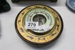 An aneroid barometer depicting the zodiac