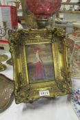 A small gilt framed oil on board of a lady