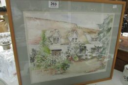 A framed and glazed watercolour of a cottage