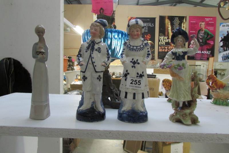 A pair of blue and white figures and 2 others