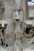A large wall mounting chandelier with crystal drops