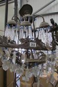 An old chandelier with blue glass buttons for restoration