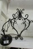 A wrought iron ceiling light with small glass florets