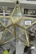 A star shaped brass and glass ceiling light