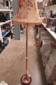 A copper post horn as a floor lamp with shade