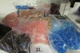 Approximately 16 bags of assorted coloured glass buttons for chandeliers