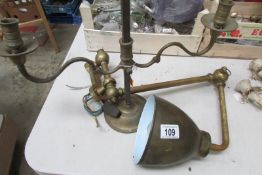 An adjustable brass candelabra and an adjustable brass reading lamp