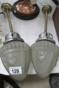 A pair of 1920's brass ceiling lights with frosted glass shades