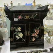 An Oriental style lacquered prayer table with handpainted floral scenes