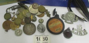 A mixed lot including silver coins, medals. buttons. fobs, Victorian crown etc