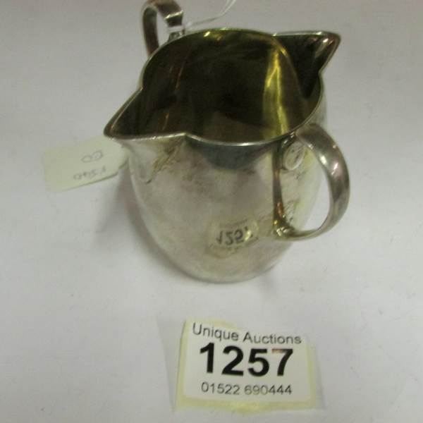 A silver jug with double lip