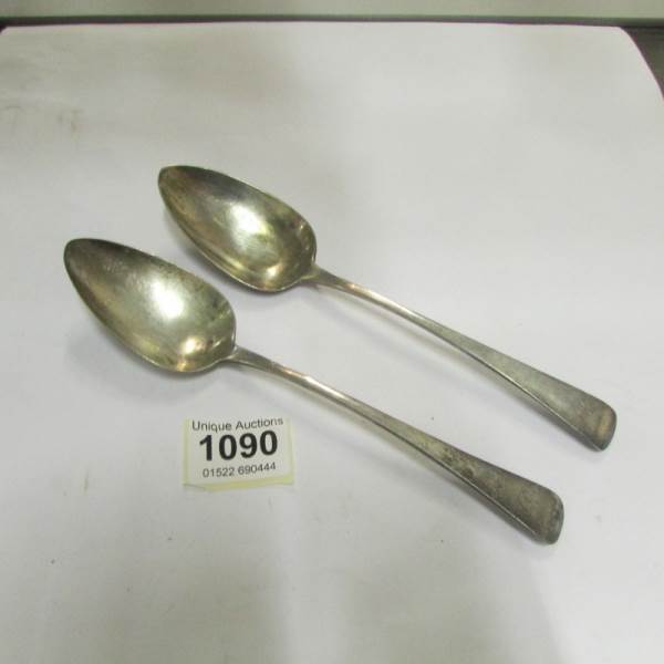 A pair of Georgian silver serving spoons
