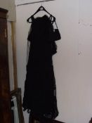 A black lace dress and evening bag