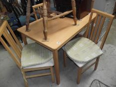 A modern kitchen table and 4 chairs