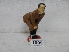 A painted figure of Hitler as a pincushion