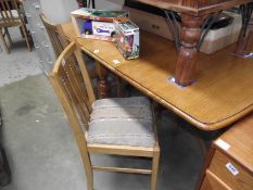 An oak drop leaf table and 4 chairs