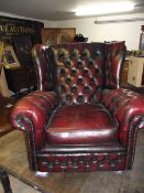 A red leather wing armchair