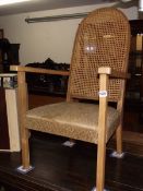 An elbow chair with cane back