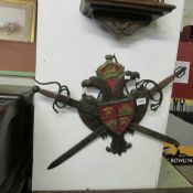 A Medieval style wall plaque with crossed swords