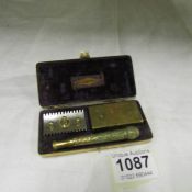 A Gillette safety razor in ornate brass case