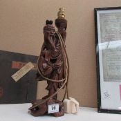 A carved Oriental figure table lamp