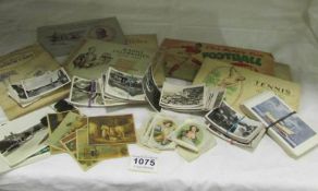 A box of various cigarette cards including silks